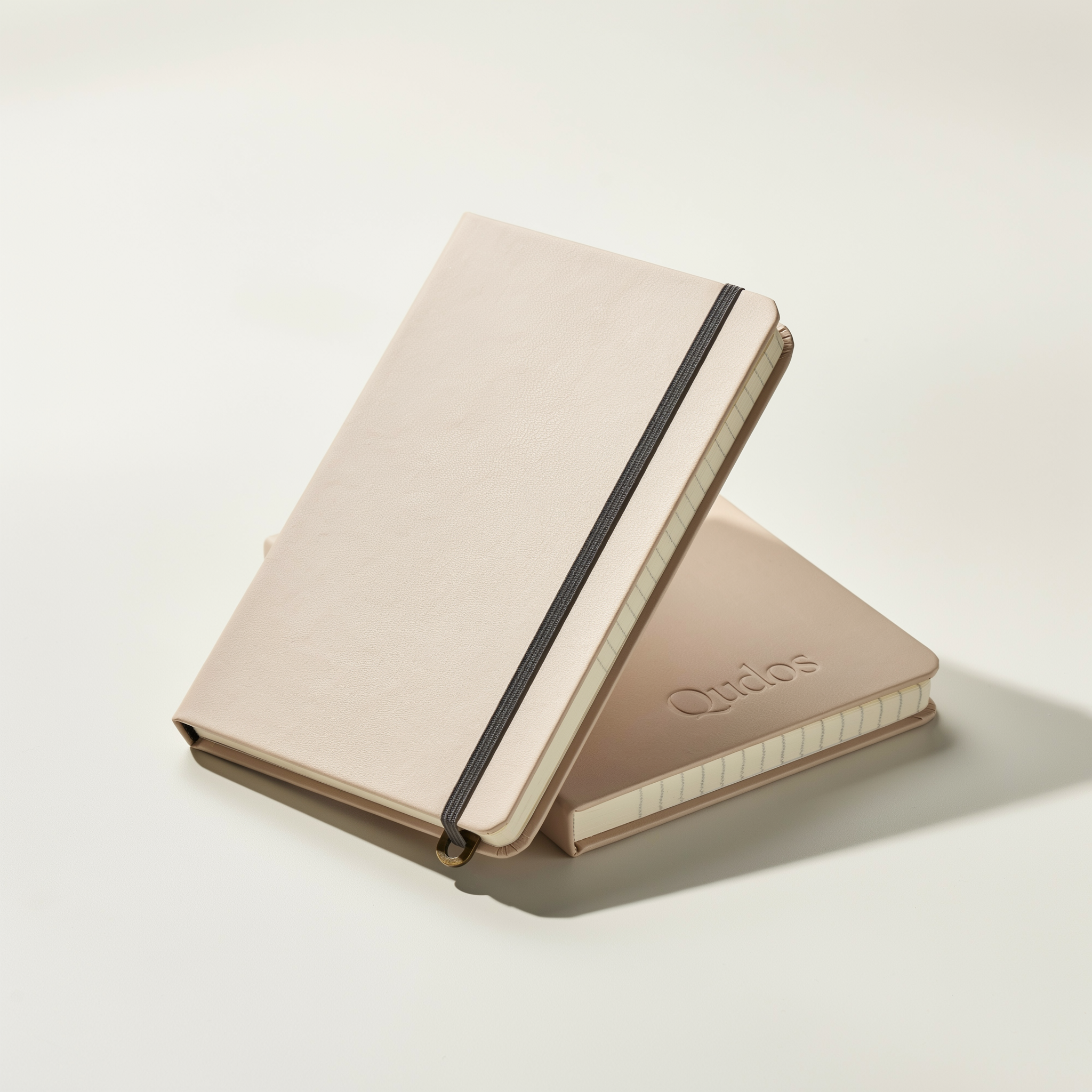 Pair of Qudos classic notebooks with elastic closure in soft beige